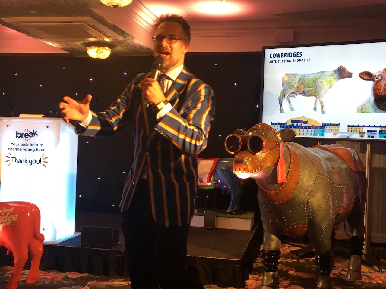 Charles Hanson in charge at the auction, with Moo Moo Tron III behind him